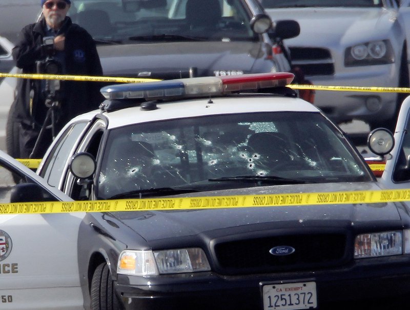 FILE - This Feb. 7, 2013 file photo shows a bullet-damaged Los Angeles Police vehicle in Corona, Calif after suspect, former Los Angeles police officer Christopher Dorner, shot at two LAPD officers in the vehicle who were sent to Corona to protect someone Dorner threatened in a rambling online manifesto. 
