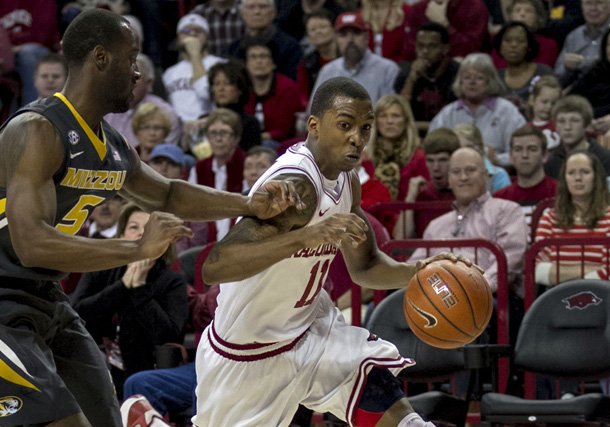 Arkansas guard BJ Young (11) drives to the basket against Missouri's Keion Bell (5) during the Razorbacks' 73-71 win over Missouri. Young scored 18 points, including seven in the final 29 seconds. (AP Photo/Gareth Patterson)