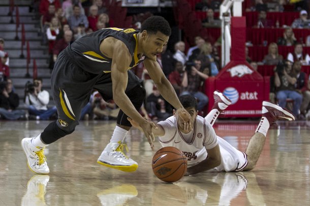 Missouri's Phil Pressey (1) loses the ball as he is guarded by Arkansas captain Kikko Haydar, right, during the second half an NCAA college basketball game in Fayetteville, Ark., Saturday, Feb. 16, 2013. Arkansas defeated Missouri 73-71. (AP Photo/Gareth Patterson)