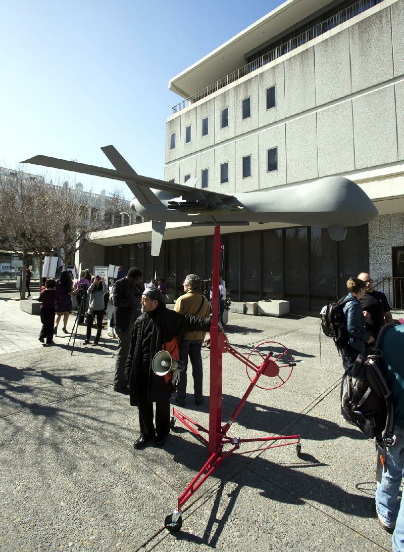 A model of a military-style drone sits Thursday outside the Alameda County Administration Building in Oakland, Calif., before a hearing on the county sheriff’s plan to acquire a drone for aerial surveillance. 