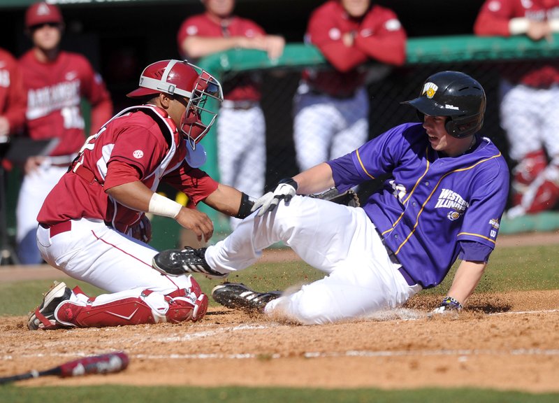 Arkansas catcher Jean Ramirez tries to tag out Western Illinois base runner Erik Maki during the fourth inning of Sunday afternoon's game at Baum Stadium in Fayetteville. Maki scored on the play. 