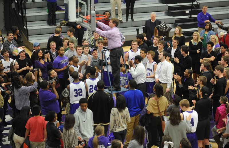 STAFF PHOTO ANDY SHUPE
Fayetteville coach Kyle Adams cuts the final strand of the net after the Bulldogs clinched the conference title with a win over Springdale Friday, Feb. 15, 2013, in Bulldog Gymnasium at Fayetteville High School.