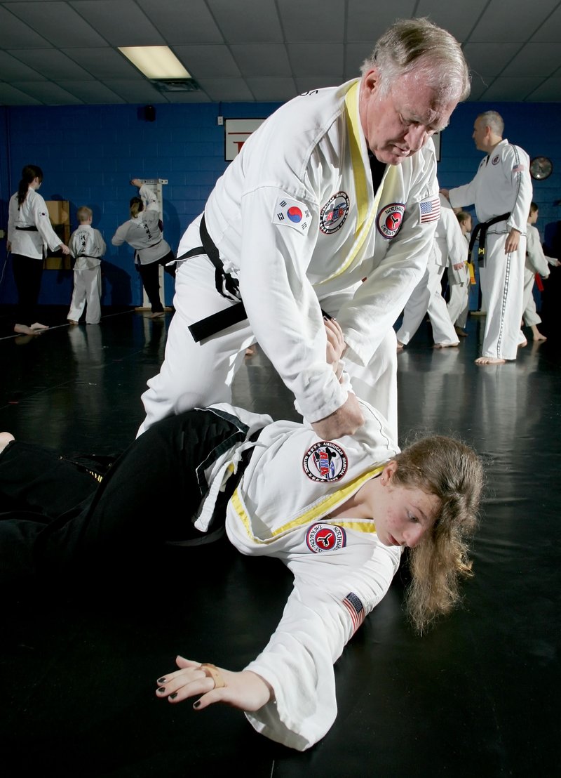 Jackson practices defense drills with black belt Savannah Barnes, 13, in class Tuesday morning at Northwest Taekwon-Do. 