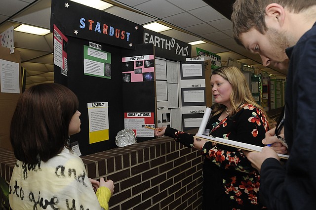 STAFF PHOTO FLIP PUTTHOFF
STAR SCIENTIST
Emily Mitchell, a student at Oakdale Middle School, talks about her science-fair entry with judges Virginia Rhame, center, and Michael Williams on Wednesday Feb. 13 2013 at the school. Emily's entry discusses the science of stardust, which is the trail of light seen behind falling stars.