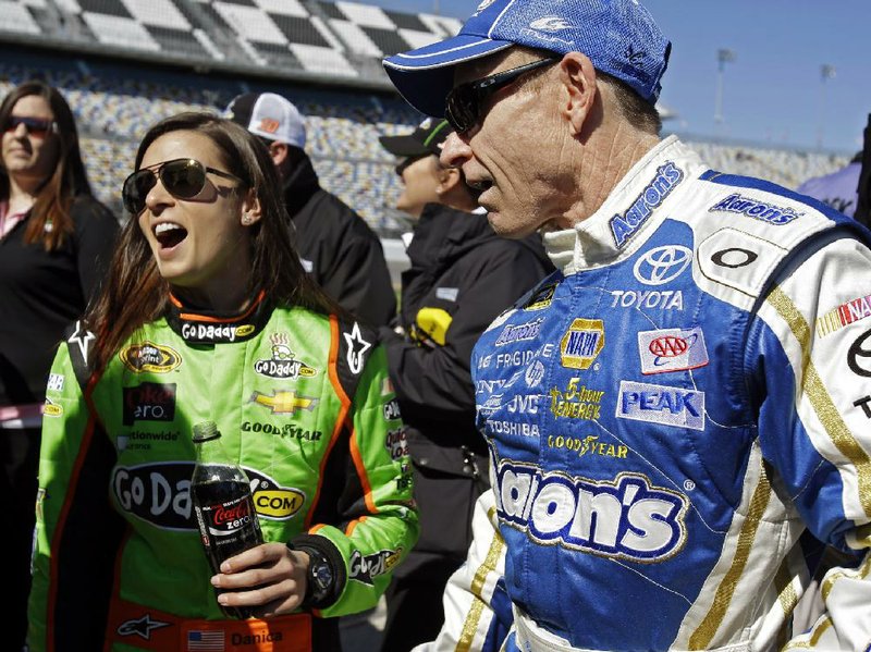 NASCAR Sprint Cup drivers Danica Patrick (left) and Mark Martin (Batesville) talk on pit row after their qualifying runs Sunday at Daytona. Patrick became the first woman to claim the pole at Daytona, while Martin checked in at 28th. Only the front row was set Sunday. Qualifying races continue Thursday. 