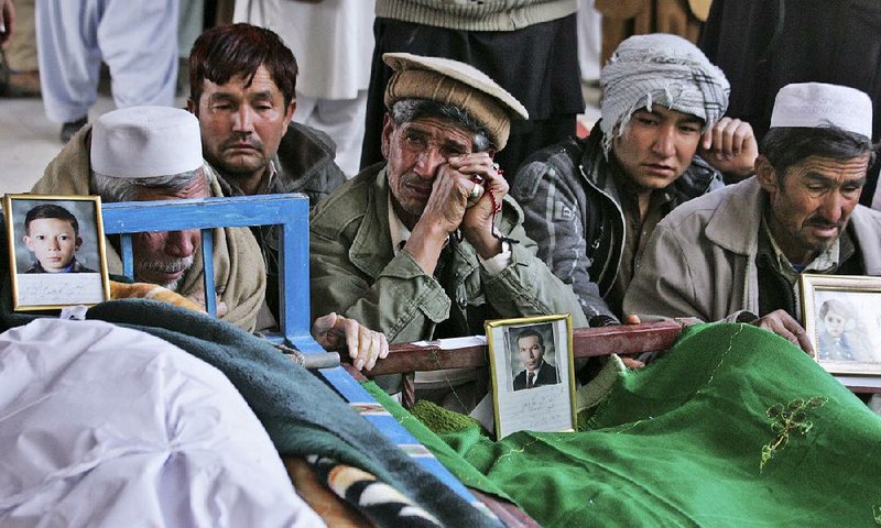 Pakistani relatives of Saturday’s bombing victims mourn next to their bodies in a mosque in Quetta, Pakistan, on Sunday. Angry Hazara Shiite Muslims demanded government protection from attacks by extremist groups.