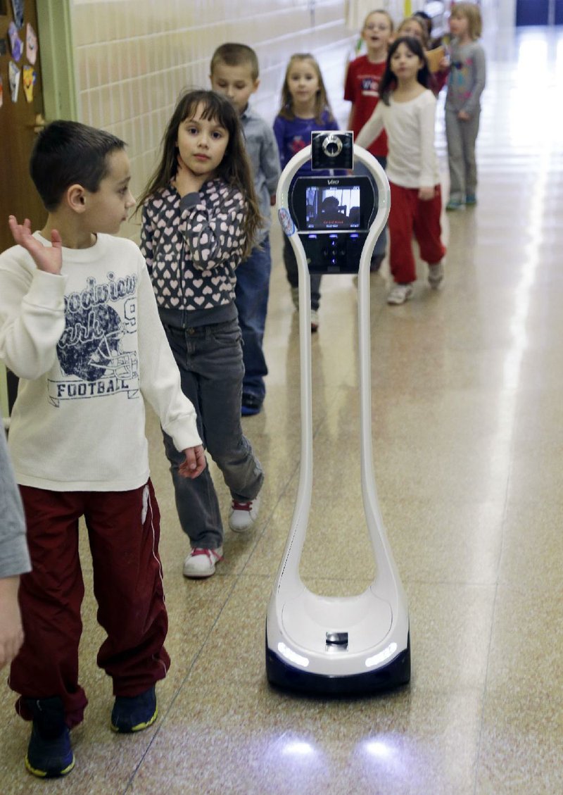 VGo robot’s wireless hookup lets Devon Carrow move down the hall with his class at Winchester Elementary School in West Seneca, N.Y. 