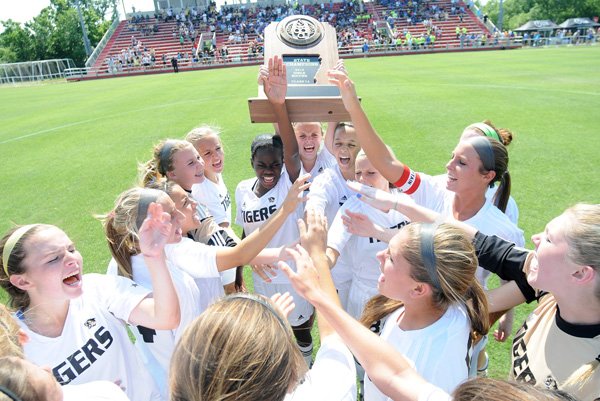 Bentonville celebrates with their Arkansas Activities Association trophy May 18 after defeating Conway 1-0 in the Class 7A Girls State Soccer Championship at Razorback Field in Fayetteville.