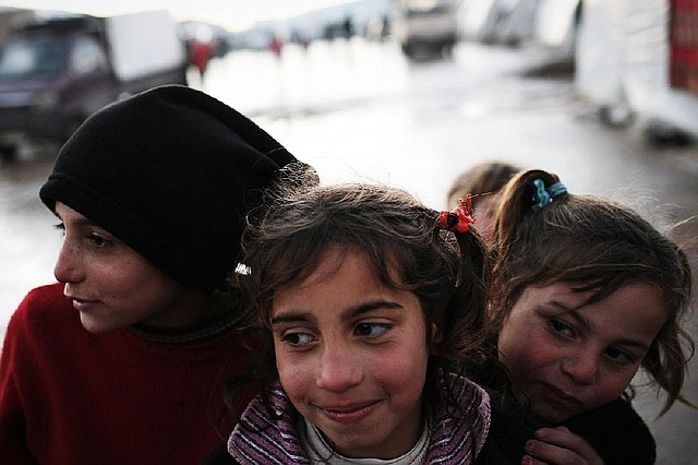 Syrian girls are seen Monday in the Azaz camp for displaced people north of Aleppo province, Syria. According to Syrian activists the number of people in the Azaz camp has grown by 3,000 in the past weeks after heavier shelling by government forces. 