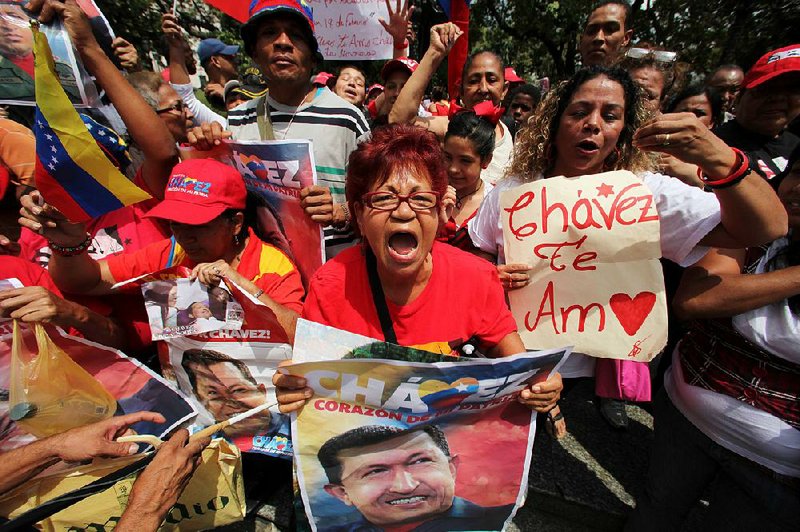 Supporters of Venezuelan President Hugo Chavez celebrate his return Monday at Bolivar Square in Caracas after more than two months of treatment in Cuba after cancer surgery.