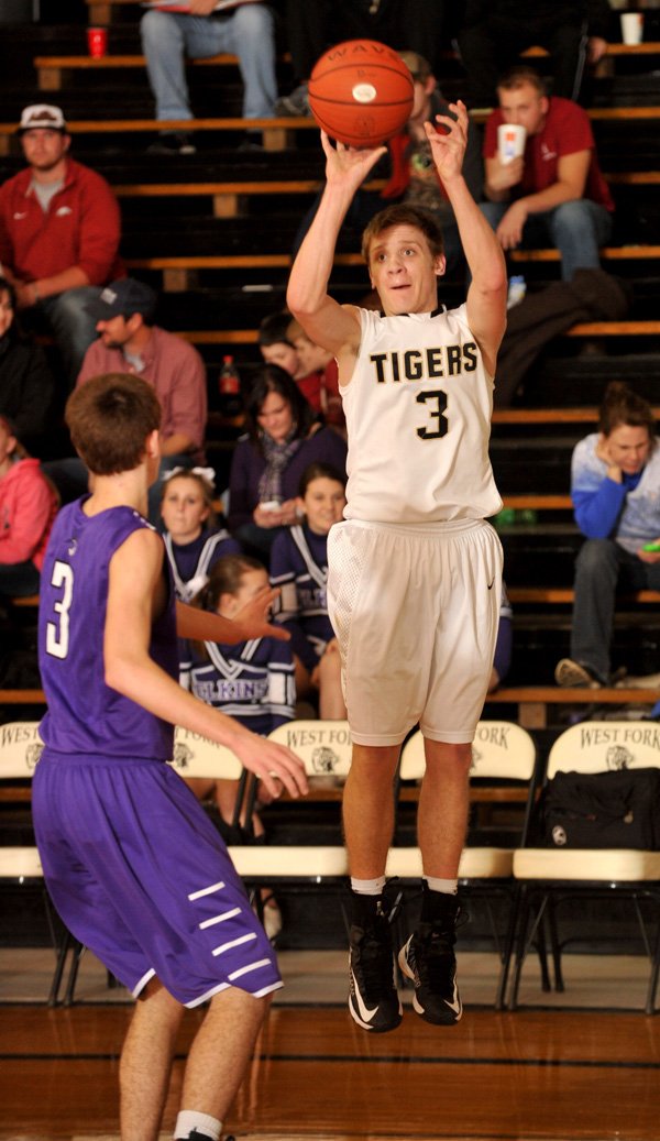 Josh Ferrell of West Fork pulls up for a 3-pointer Wednesday over Elkins defender Dillon Gash in West Fork. 