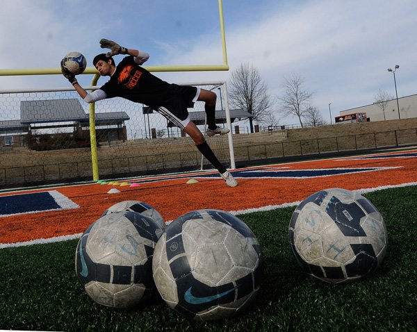 Javier Piedra works out during a goalkeeping drill Thursday at Rogers Heritage High School soccer practice. 