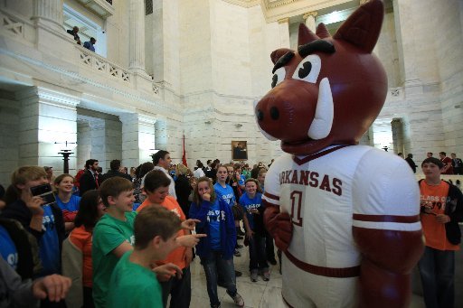 Sixth graders from Rose Bud Elementary gather around the Razorback mascot Tuesday afternoon during Razorback Day at the Capitol.