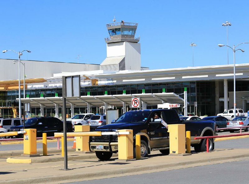  A visitor to Bill and Hillary Clinton National Airport gets a parking ticket Tuesday afternoon. Parking rates will go up at the airport beginning in April as patrons begin paying sales tax for parking. Previously the sales tax was included in the parking rate. 