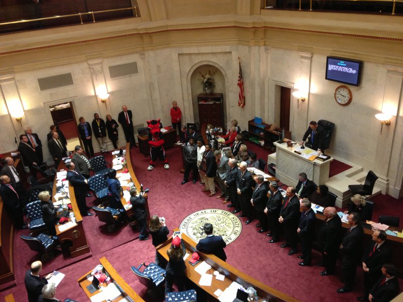 Members of the Arkansas State football team and officials from the school stand before the Arkansas State Senate to be honored for their 2012 football season on Wednesday at the State Capital. The Red Wolves went 10-3 and won the GoDaddy.com Bowl 17-13 over No. 25 ranked Kent State.