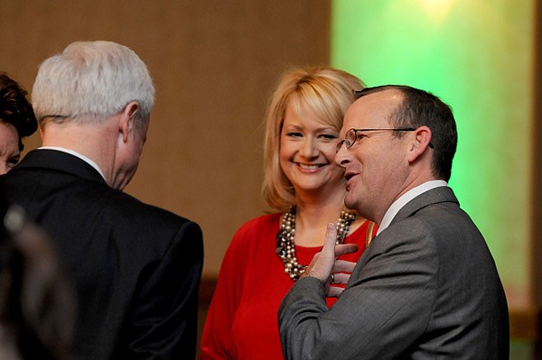 Mike Luttrell, right, talks Tuesday with wife Debbie Luttrell and Howard Hamilton, left, at the annual Springdale Chamber meeting at the Northwest Arkansas Convention Center in Springdale. Luttrell was given the 45th Annual Civic Service Award later in the evening.