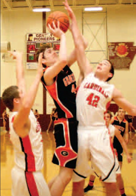Gravette junior center Otto Troutner attempts two under the basket but is blocked by Farmington during semifinals play in Gentry on Friday. 