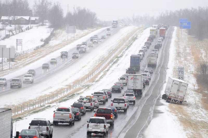 Traffic heading south on Interstate 540 slows Wednesday Feb. 20, 2013 between Springdale and Johnson. Snow fall in northwest Arkansas caused some traffic difficulties on the highway including vehicles that slid off the road. Springdale schools were closed an hour early due to the inclement weather.