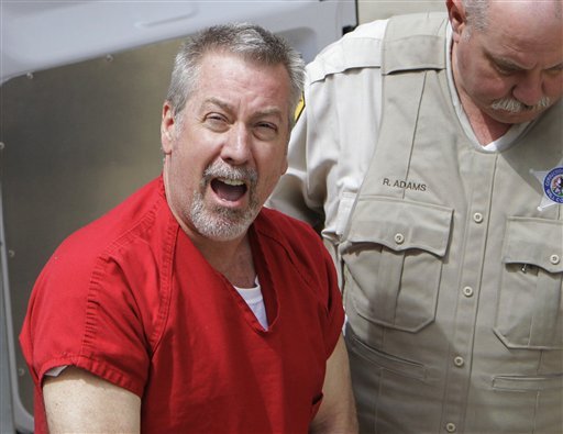 In this May 8, 2009 file photo, former Bolingbrook, Ill., police sergeant Drew Peterson arrives at the Will County Courthouse in Joliet, Ill., for his arraignment on charges of first-degree murder in the 2004 death of his third wife Kathleen Savio. On Thursday, Feb. 21, 2013, Will County Judge Edward Burmila sentenced Peterson to 38 years in prison for Savio's murder.