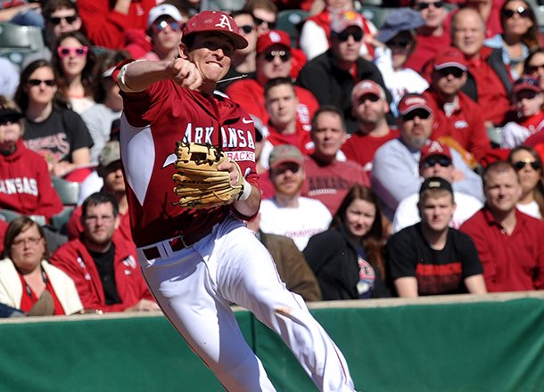 Arkansas infielder Willie Schwanke makes a play to throw out a Western Illinois runner in the second inning of Sunday afternoon's game at Baum Stadium in Fayetteville.
