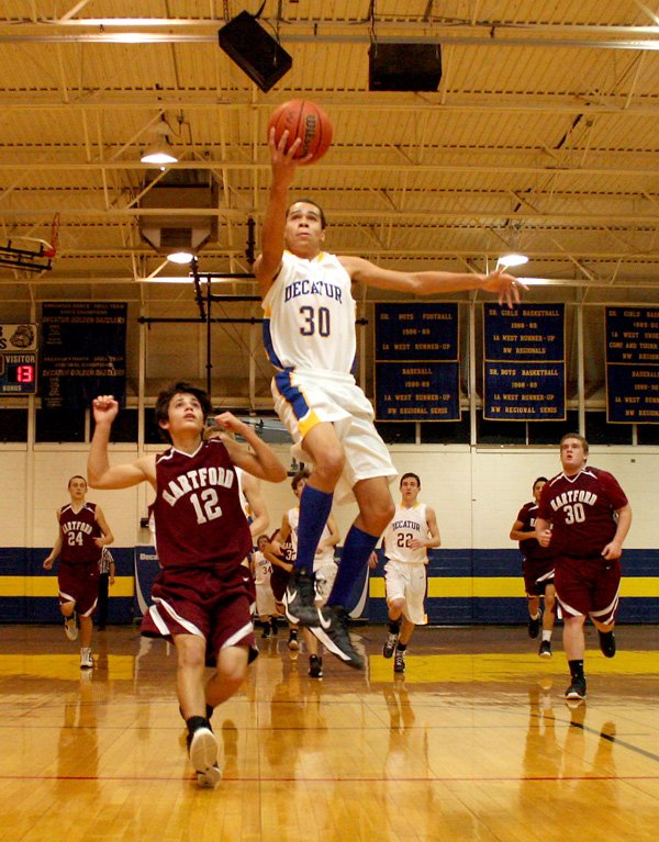 Andrew Harris, a Decatur senior forward, breaks away from Hartford’s Brody Funk and puts up a shot during play on Friday night at Decatur. 