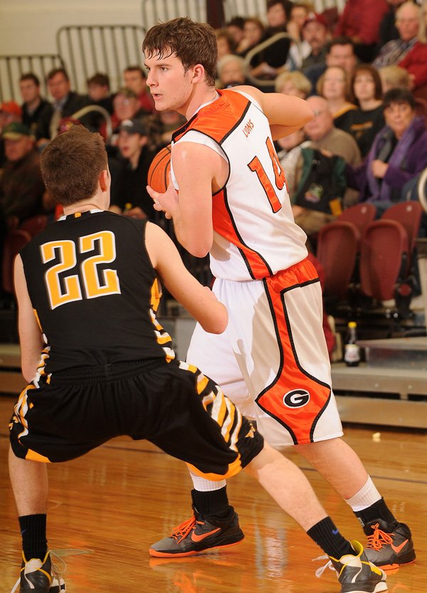 Gravette’s Quinten Parker looks to pass the ball during the Lions’ game Feb. 13 against Prairie Grove in Gentry. 