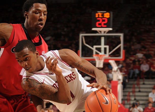 Arkansas guard BJ Young drives the ball Georgia Thursday at Bud Walton Arena. Young hit a game-winning shot with 5.3 seconds left as the Razorbacks won 62-60.