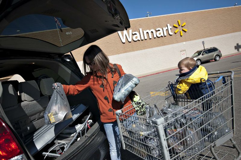 Jen Dickinson on Wednesday unloads groceries after shopping at a Wal-Mart store in East Peoria, Ill. 