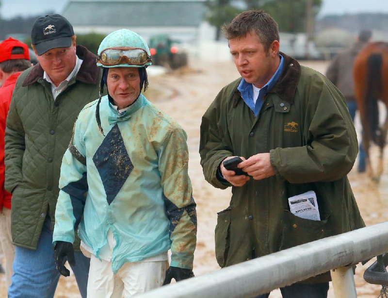 Jockey Calvin Borel (left) talks with trainer Ron Moquett after fi nishing fi fth aboard Bold Choice in Thursday’s eighth race at Oaklawn Park in Hot Springs. Borel, 46, is one victory short of 5,000 for his career. 