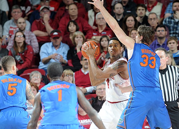 Arkansas' Coty Clarke is surrounded by Florida's defense in the first half of the game Tuesday, Feb. 5, 2013, at Bud Walton Arena in Fayetteville. The Razorbacks upset the Gators, winning 80-69.