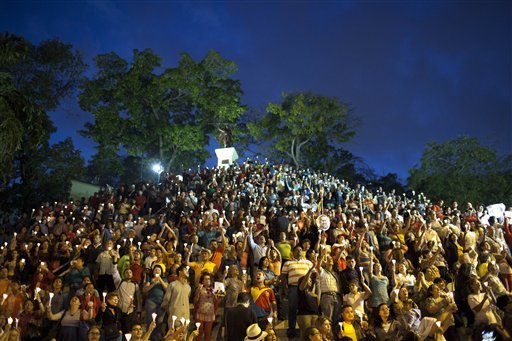 People hold up candles during candlelight vigil for Venezuela's President Hugo Chavez to pray for his health as he remains in a hospital undergoing cancer treatment, in Caracas, Venezuela, Friday, Feb. 22, 2013. The government has not given details about the treatment Chavez is undergoing, and hasn't identified the type or exact location of the tumors that have been removed from his pelvic region.