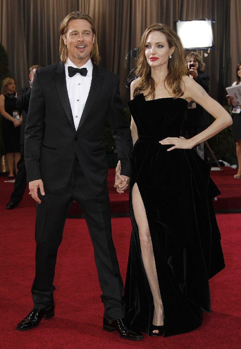 What are they wearing? A-listers Brad Pitt and Angelina Jolie pose before the 2012 Oscars. Jolie’s bared leg caused the biggest buzz on the red carpet last year. 