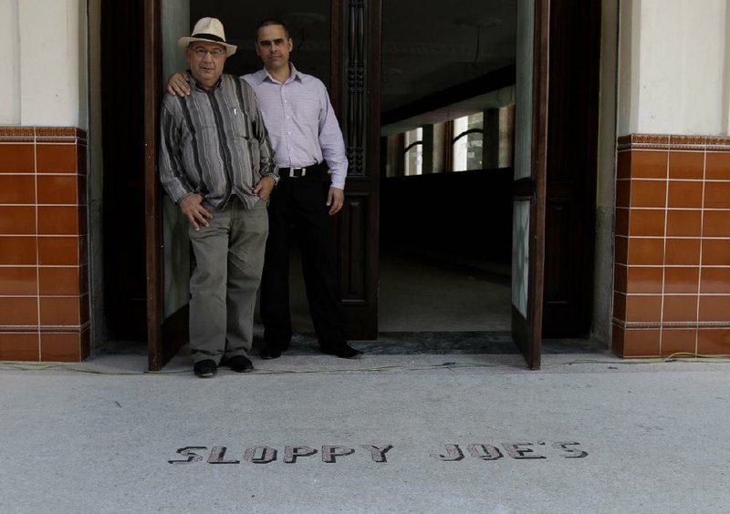 Jose Rafa Malem and Ernesto Iznaga pose in the entrance of Sloppy Joe’s Bar in Havana. The historic bar will be reopened soon by the state-run tourism concern Habaguanex. 