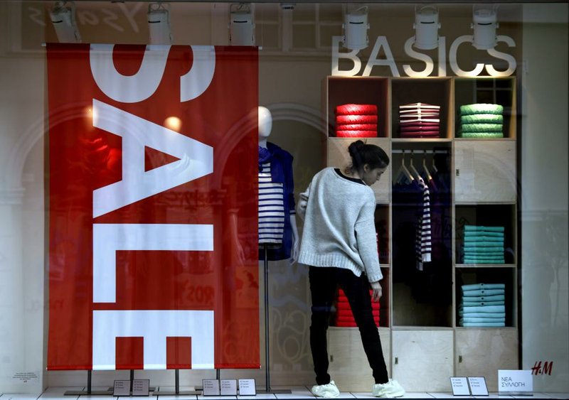 A clothing-store employee arranges a window display in Athens, Greece, in January. European Union officials on Friday predicted another year of recession in the 17-nation eurozone. 