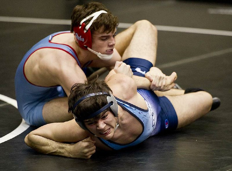 Fort Smith Southside’s Isaac Smith (top) puts an arm lock on Springdale Har-Ber’s Grant Thornton (bottom) during a 145-pound match Friday at the state high school wrestling tournament at the Jack Stephens Center in Little Rock. Smith won the match, pinning Thornton at the 2:46 mark. Smith advanced to today’s semifinals. 