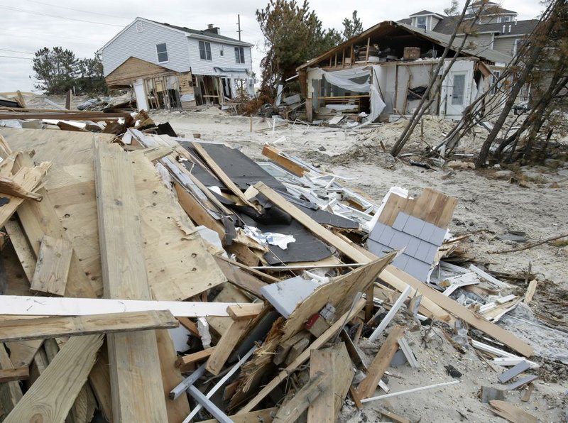 Debris remains strewn around Sandy-damaged homes Friday at Mantoloking, N.J. 