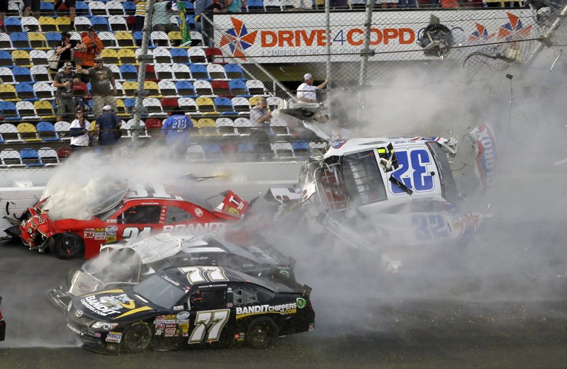 Kyle Larson (32) is airborne after a multi-car crash, including Parker Kilgerman (77), Justin Allgaier (31) and Brian Scott (2) during the final lap of the NASCAR Nationwide Series auto race at Daytona International Speedway, Saturday, Feb. 23, 2013, in Daytona Beach, Fla. Larson's car collided with the catch fencing.