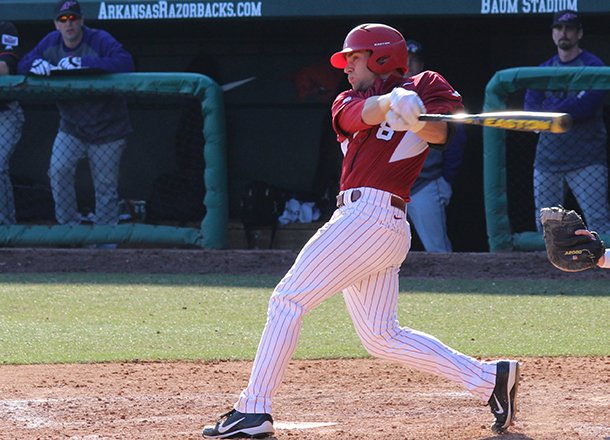 Tyler Spoon hits a grand slam home run during the eighth inning of a game against Evansville on Saturday, Feb. 23, 2013 at Baum Stadium in Fayetteville. 