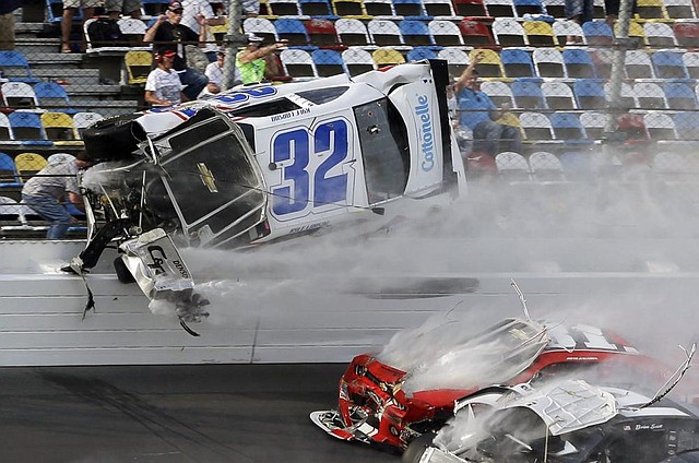 Kyle Larson’s car (32) goes airborne into the catch fence during a multi-car crash involving Justin Allgaier (31), Brian Scott (2) and others during the final lap of Saturday’s NASCAR Nationwide Series race at Daytona International Speedway in Daytona Beach, Fla. 
