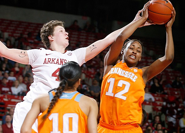 Arkansas senior Sarah Watkins and Tennessee freshman Bashaara Graves vie for a rebound during the second half on Sunday, Feb. 24, 2013, at Bud Walton Arena in Fayetteville.