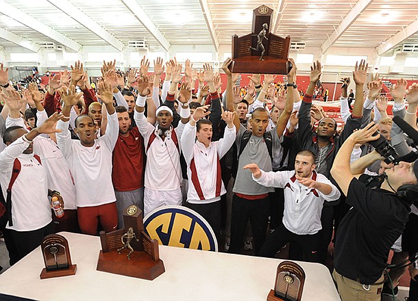 Arkansas athletes celebrate after the men's and women's teams won conference titles Sunday, Feb. 24, 2013, during the Southeastern Conference Indoor Track and Field Championships at the Randal Tyson Track Center in Fayetteville.