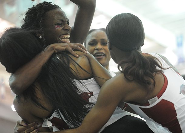 Arkansas sprinters, from left, Regina George, Sparkle McKnight, Gwendolyn Flowers and Chrishuna Williams celebrate a win in the 4x400-meter relay that gave the Razorbacks a conference title Sunday, Feb. 24, 2013, during the Southeastern Conference Indoor Track and Field Championships at the Randal Tyson Track Center in Fayetteville.