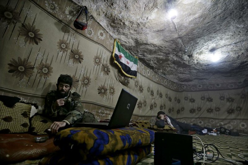 Abu al-Yaman, one of the commanders of the Knights of the North brigade, speaks with his comrade through Skype at Jabal al-Zaweya in Idlib, Syria, on Sunday. 