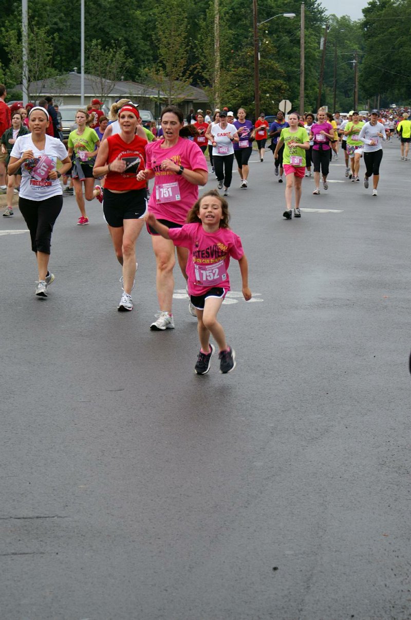 Clara Nikkel (No. 752) and her mother, Amanda Nikkel (751), approach the finish line of the 2012 Women Can Run/Walk 5K in Conway, demonstrating the fitness they achieved through 10 weeks of training with the Women Run Arkansas clinic in their hometown, Batesville. 