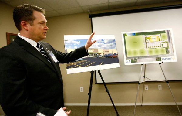 Brian Hooper, Walmart Stores vice president of real estate, discusses plans for a Walmart Neighborhood Market at the intersection of I Street and Southwest Regional Airport Boulevard in Bentonville during a news conference on Monday inside the Bentonville Chamber of Commerce. The new Neighborhood Market will be about 41,000 square feet and is scheduled to open in the fall. 
