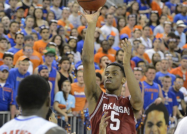 Arkansas guard Anthlon Bell (5) shoots for the basket as Florida's Casey Prather (24) watches during the second half of an NCAA college basketball game in Gainesville, Fla., Saturday, Feb. 23, 2013. Florida won 71-54. (AP Photo/Phil Sandlin)