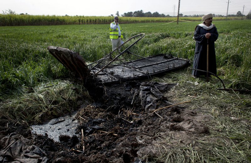 An Egyptian inspector of the Civil Aviation Authority, left, works at the site of the balloon accident, in Luxor, Egypt, on Tuesday, Feb. 26, 2013.