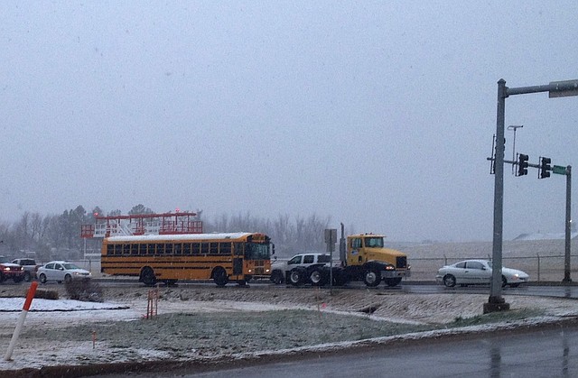 Snow fell on traffic Tuesday morning near the Springdale Municipal Airport.