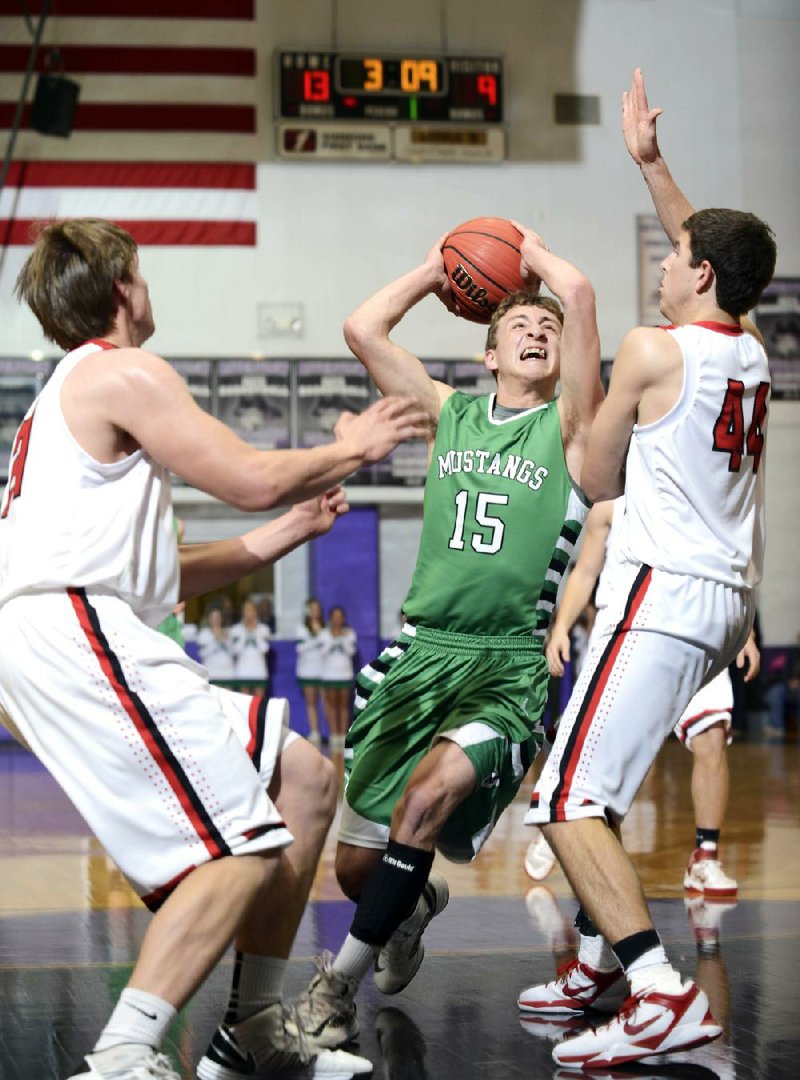 Hoxie's Colton Watson (15) looks to make the shot between Harding's William Francis (21) and Hayden Matthews (44) during the first round of the 3A state high school basketball tournament held Tuesday at Riverview High School in Searcy.