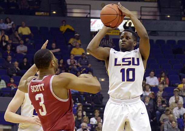 LSU's Andre Stringer (10) shoots a 3-pointer against Arkansas' Rickey Scott (3) during their NCAA college basketball game, Wednesday, Feb. 27, 2013, in Baton Rouge, La. (AP Photo/The Advocate, Heather McClelland)